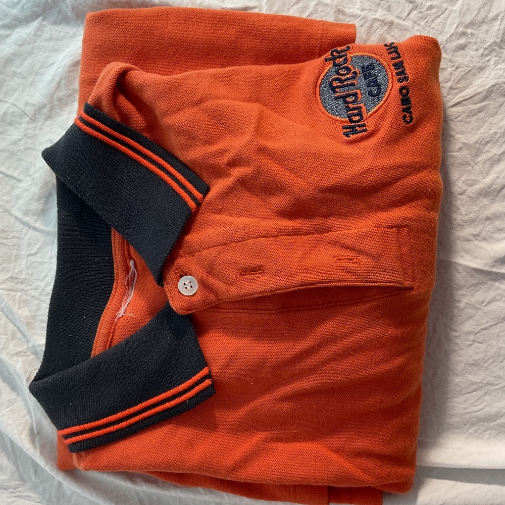 Hard Rock Cafe polo from Cabo San Lucas, MX, in orange with navy blue color.